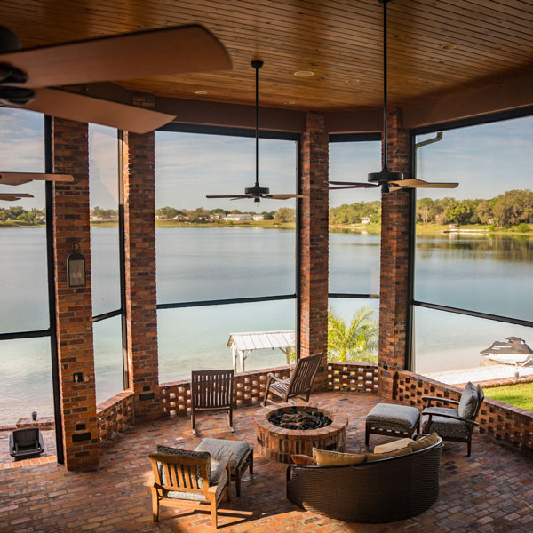 view of lake from inside covered patio with motorized shades installed by Ventana Outdoor Shades & Awnings in Houston, TX