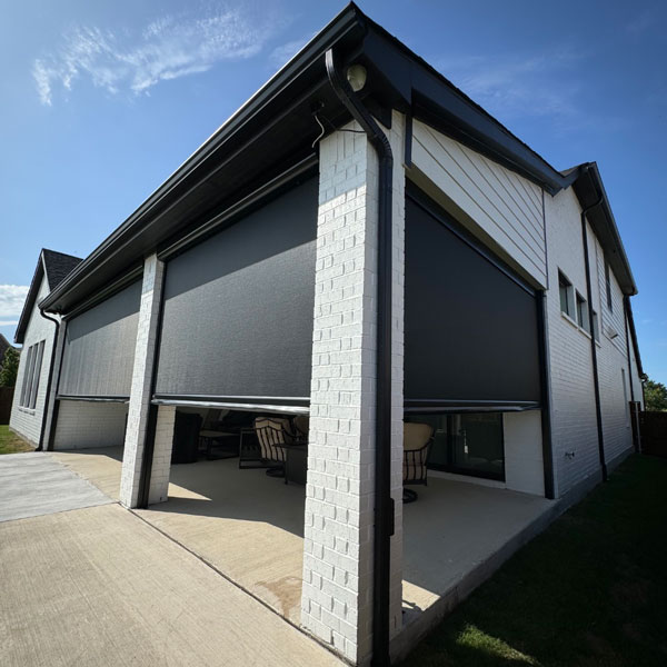 large covered patio with motorized shades installed by Ventana Outdoor Shades & Awnings in Houston, TX