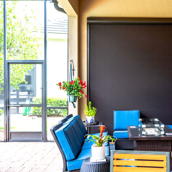large exterior window covered with motorized shades installed by Ventana Outdoor Shades & Awnings in Houston, TX