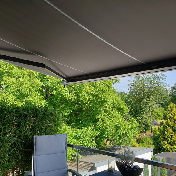 second floor patio seating area with motorized awning
